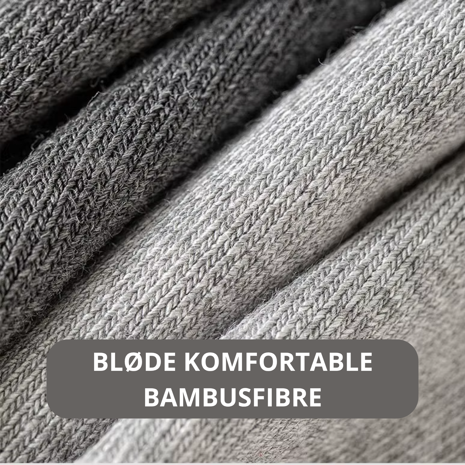 Tæt nærbillede af blød og tæt bambus fiber struktur i grå og mørkegrå nuancer – detaljefoto med teksten Bløde komfortable bambusfibre – Bambus strømper | BIBAMBUS 'Lovely Bamboo Feet'